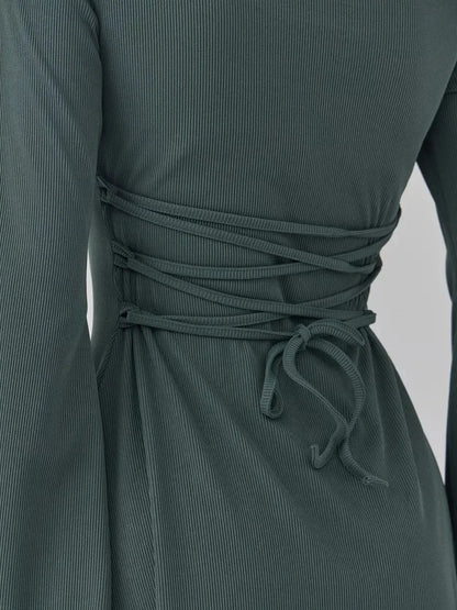 Close-up of the back lace-up detail on the Sculpt Flare dark olive mini dress, showcasing its stylish design and silhouette.