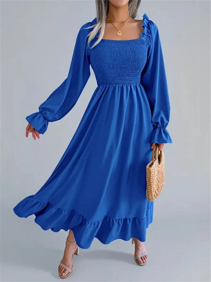 Serena Midi Dress in blue with smocked bodice, romantic ruffles, and long sleeves, perfect for weddings and special occasions.