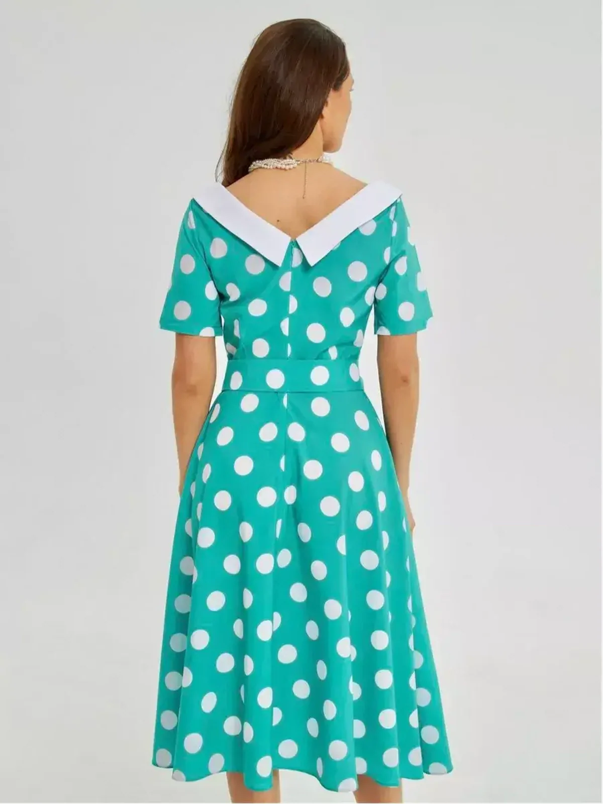 Back view of the Polka Grace Midi Dress featuring a retro polka dot pattern and white collar, ideal for summer events.
