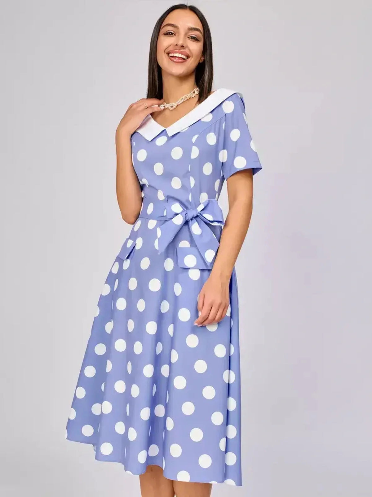 Sky blue midi dress with white polka dots and a contrast collar, perfect for summer weddings and formal events.