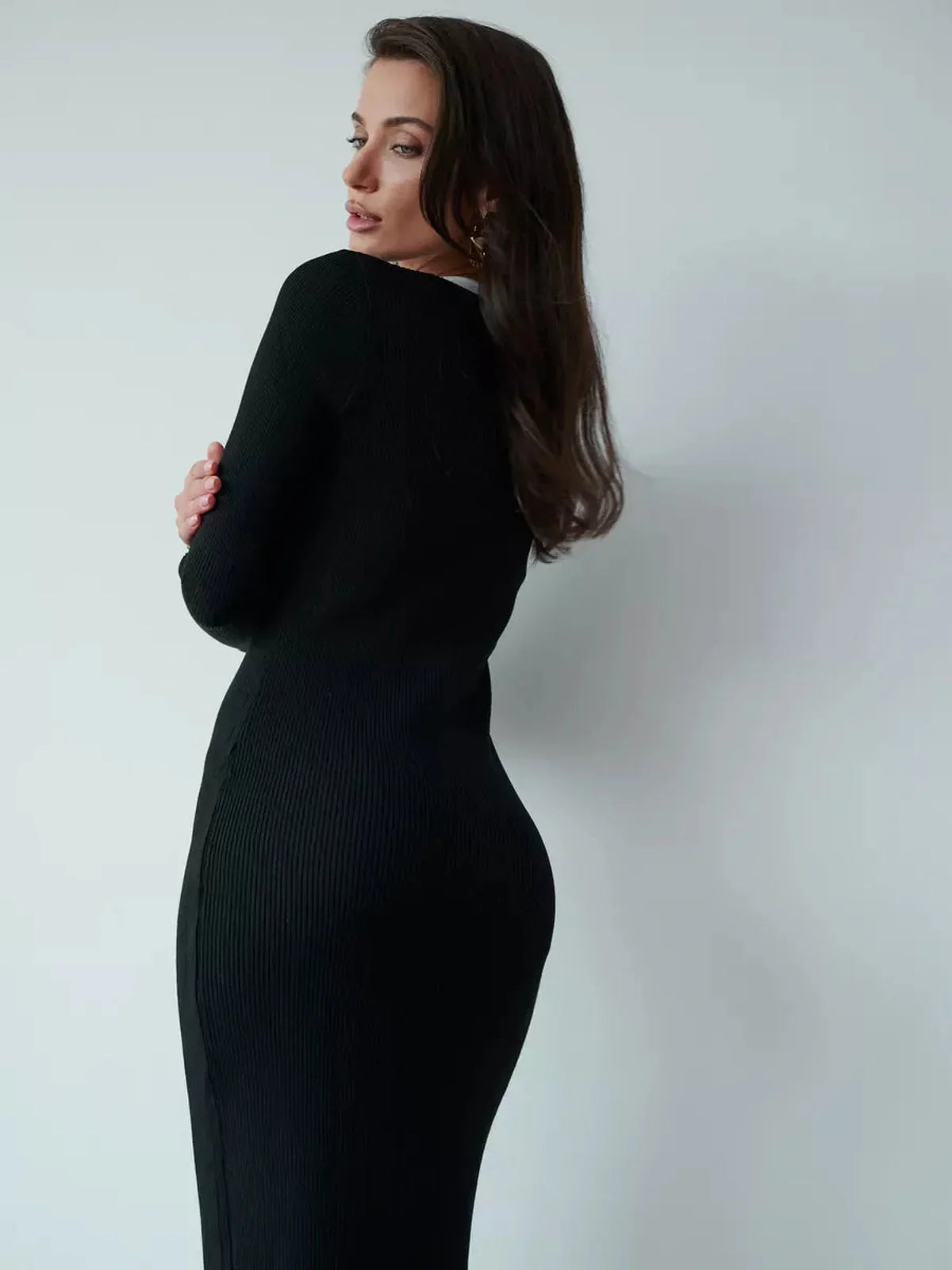 Sculpting black midi dress with long sleeves and a sleek silhouette, ideal for wedding guest or formal occasions.