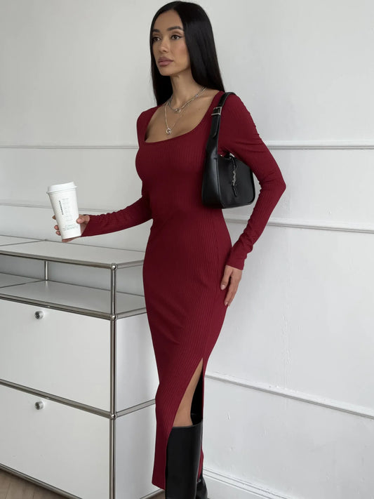Model in a burgundy Ribbed Grace Midi Dress with side slit, perfect for weddings and special occasions.