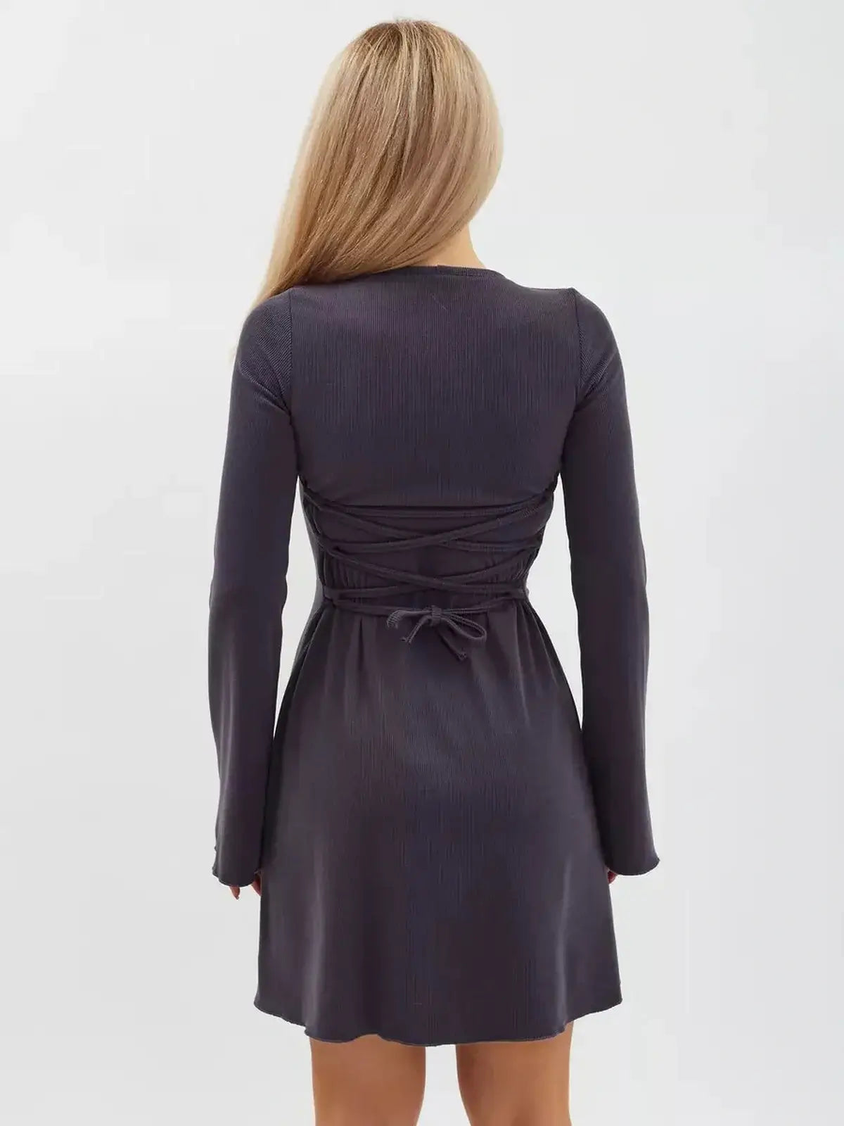 Back view of the Graphite Charm Mini Dress featuring flared sleeves and lace-up tie detail, perfect for formal or casual events.
