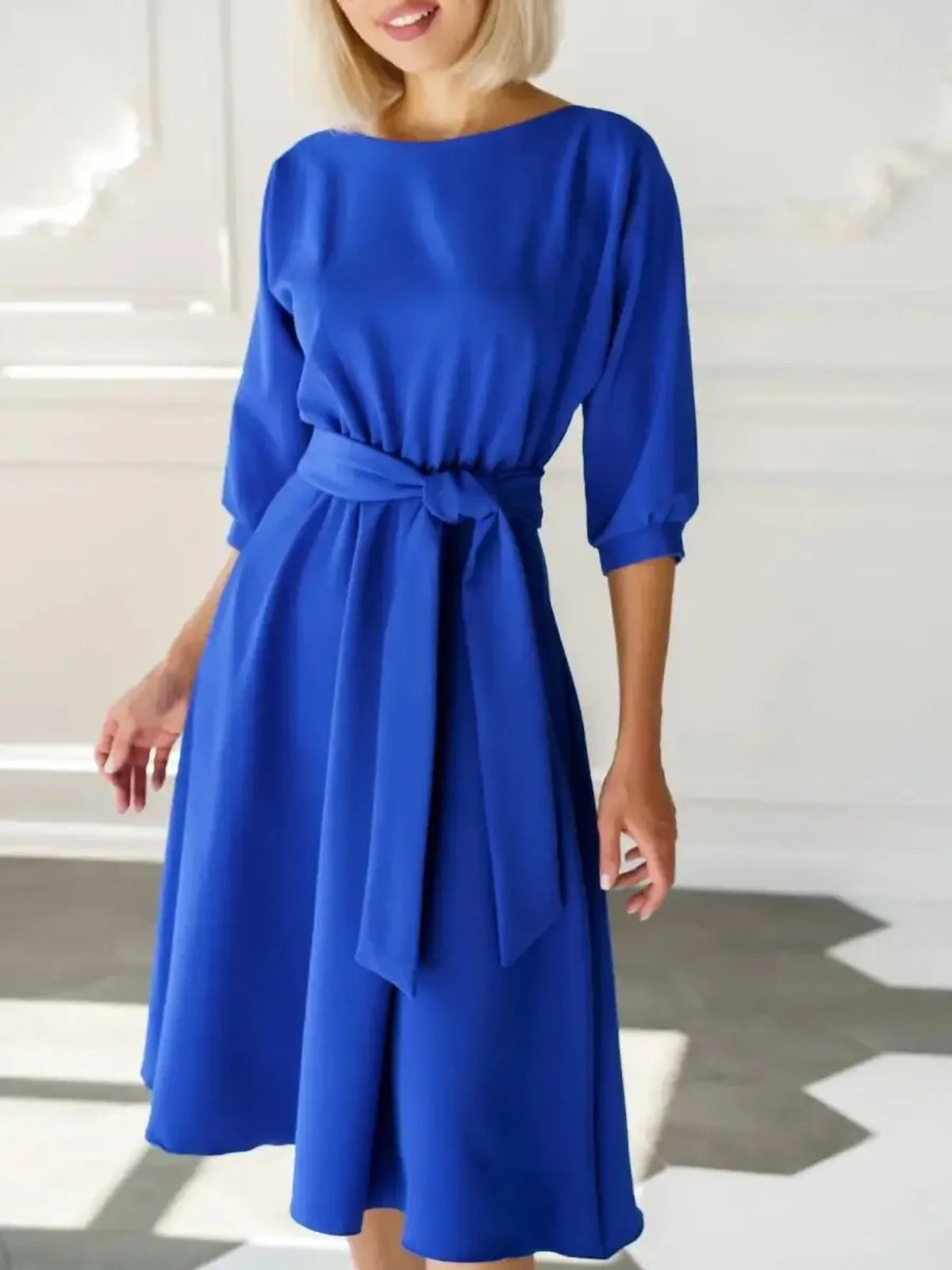 Sapphire belted midi dress in electric blue, featuring a structured neckline and A-line silhouette.