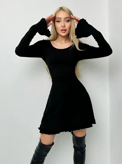 Sleek black Velvet Lace Mini dress featuring long sleeves and playful ruffled hem, perfect for cocktail or homecoming events.