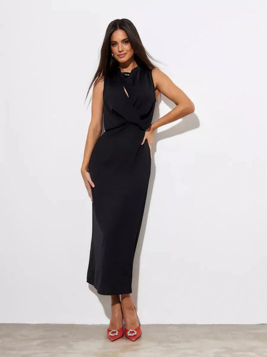 Model showcasing the Noir Drape Maxi Dress, a timeless black gown perfect for formal occasions and elegant events.