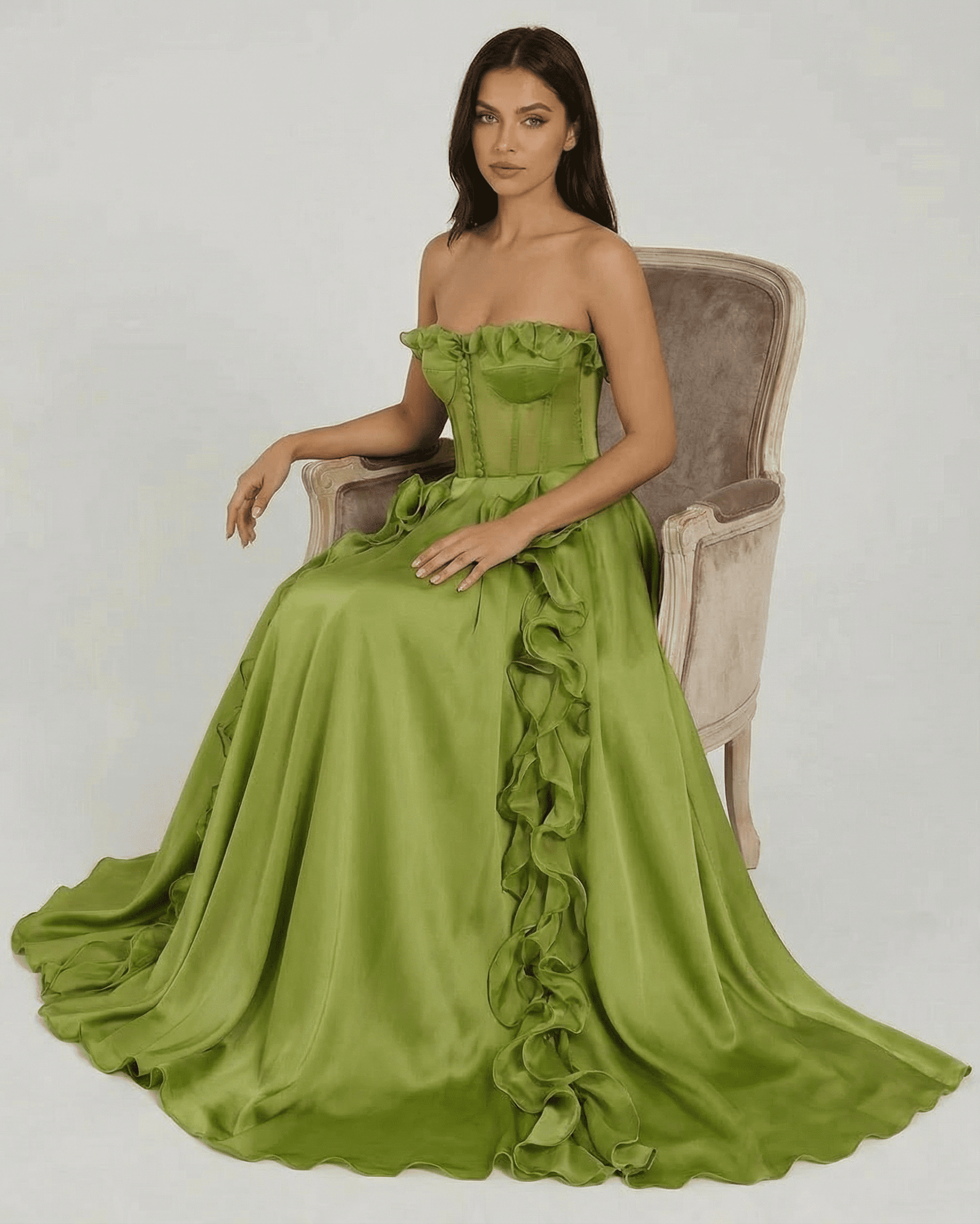Elegant woman wearing the Verdessa Maxi Dress by Slimona, a strapless green maxi dress with ruffle detail.