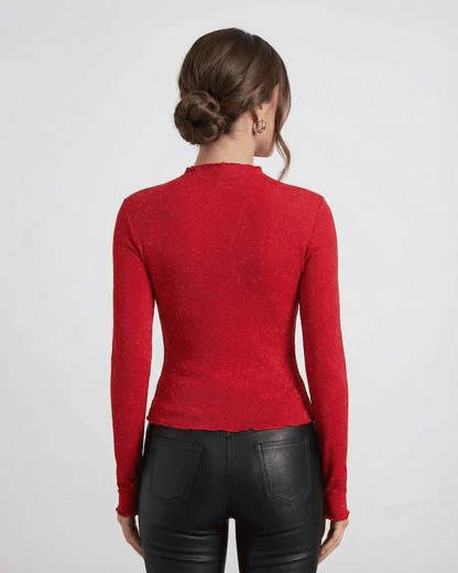 Back view of a model wearing the Slimona Scarlet Blouse, a long sleeve sequin blouse in bold red.