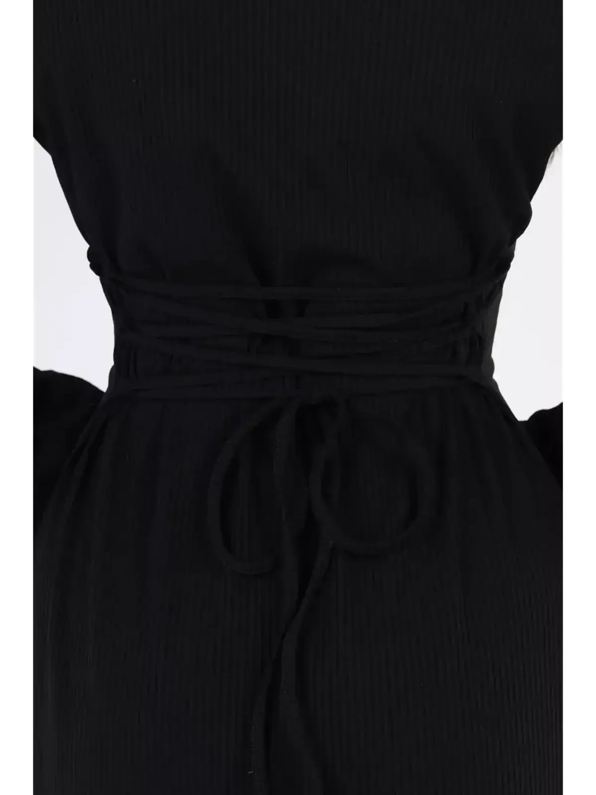 Close-up of the back detail of the Noir Flare Midi Dress showcasing a stylish tied waist in ribbed black fabric.