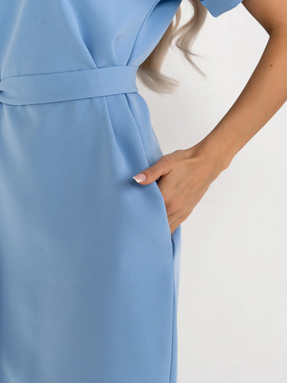 Detail shot of a light blue mini dress showcasing a stylish self-tie belt and a relaxed sheath silhouette.
