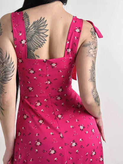 Back view of the Rosé Charm Midi Dress showcasing its floral print and adjustable shoulder tie detail.