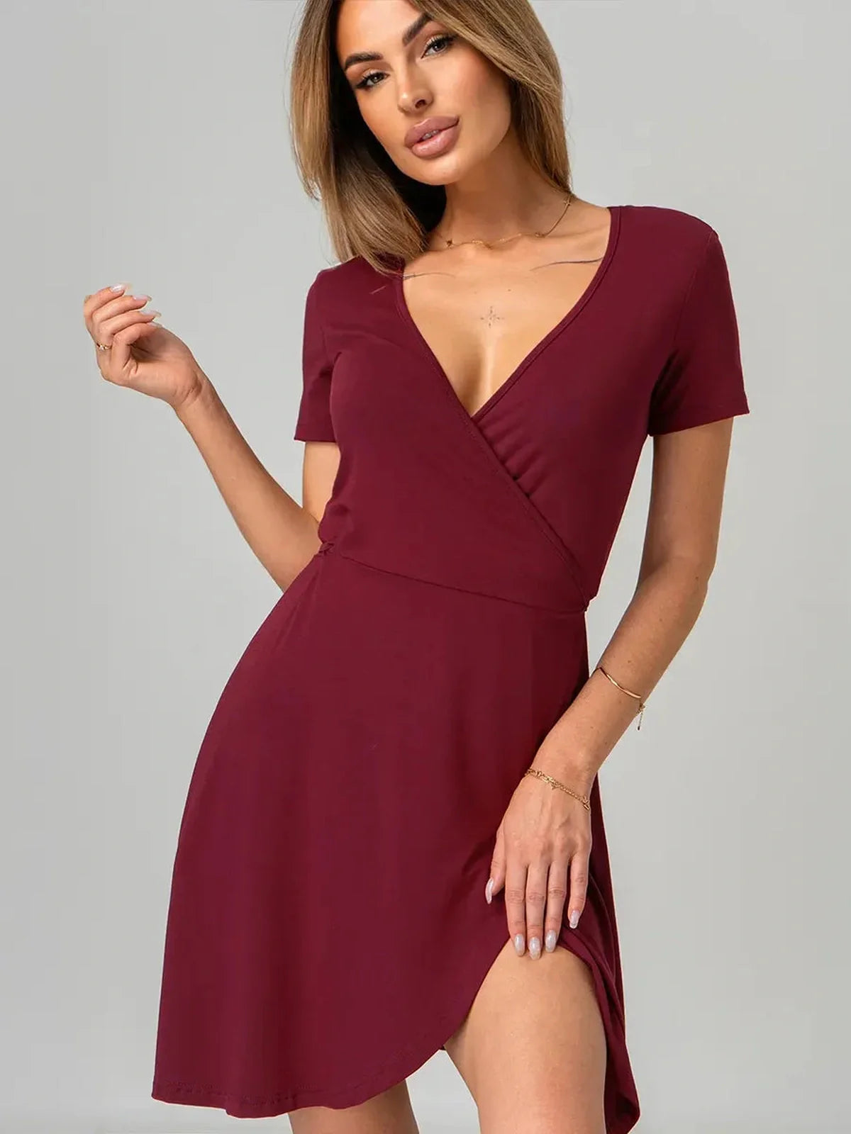 Sleek deep red wrap hour mini dress featuring a V-neckline and adjustable tie waist, perfect for any occasion.