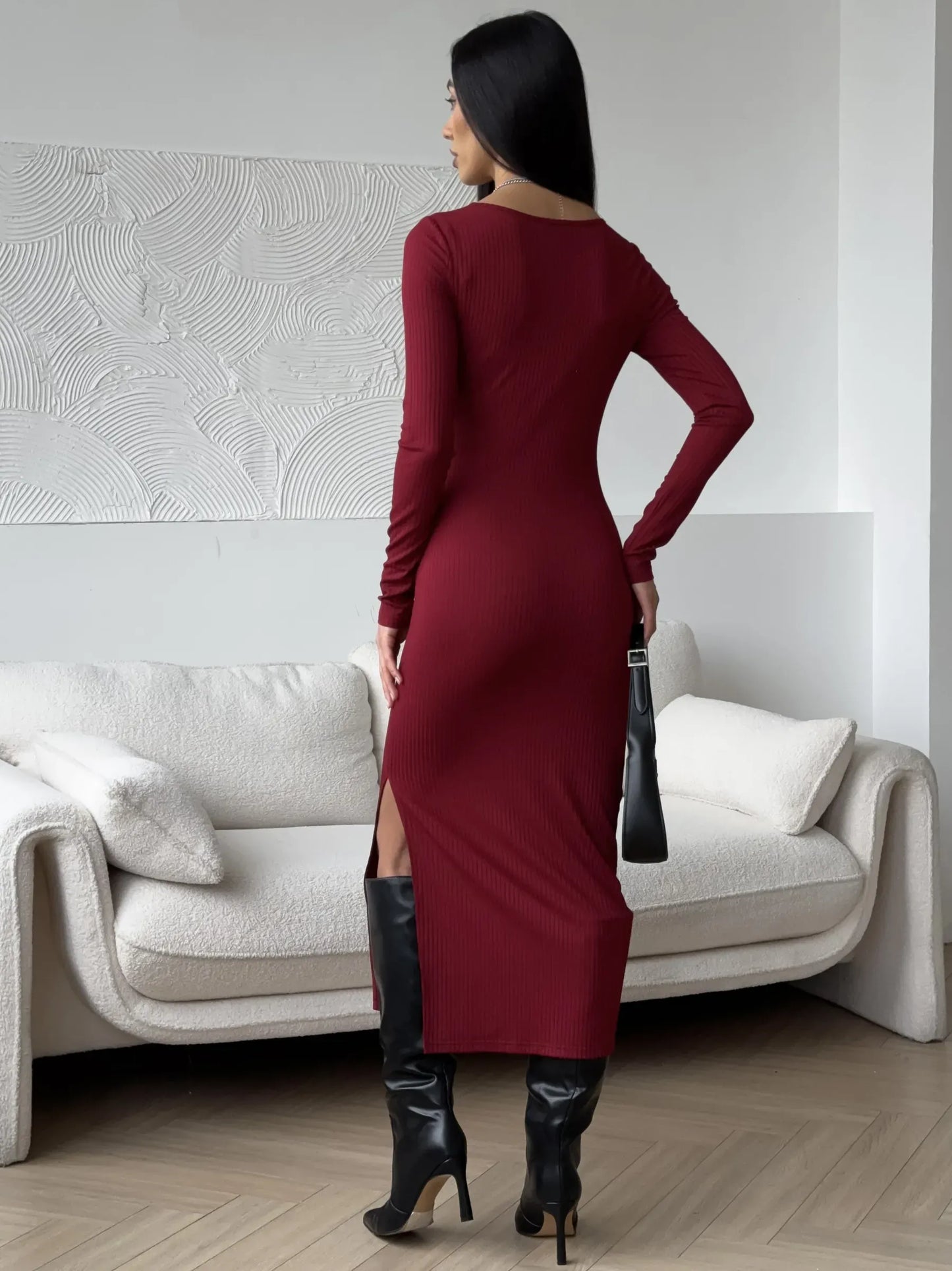 Back view of a woman in a burgundy midi dress with side slit, perfect for wedding guest or formal occasions.