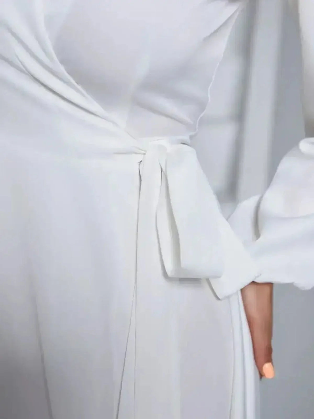 Close-up of the Ivory Whisper dress showcasing its wrap design and adjustable waist tie, perfect for summer or formal occasions.