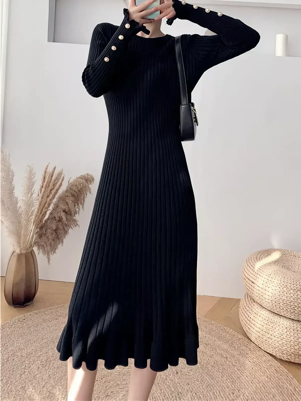 Sculpted Pearl Midi Dress in black ribbed knit with pearl buttons and ruffled hem, ideal for formal or casual occasions.