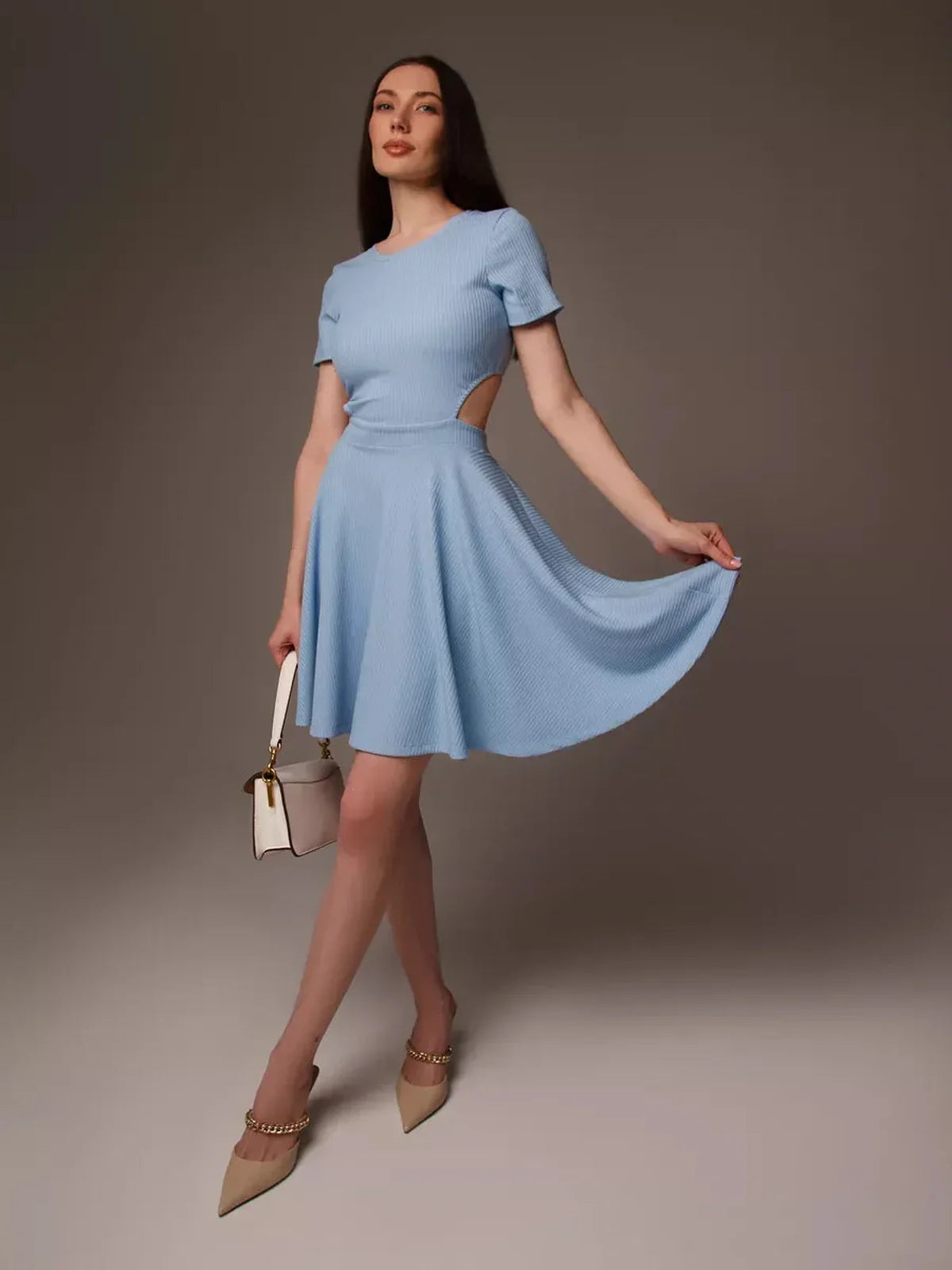 Model in a light blue mini dress with cut-out waist, perfect for summer and various occasions like weddings and parties.
