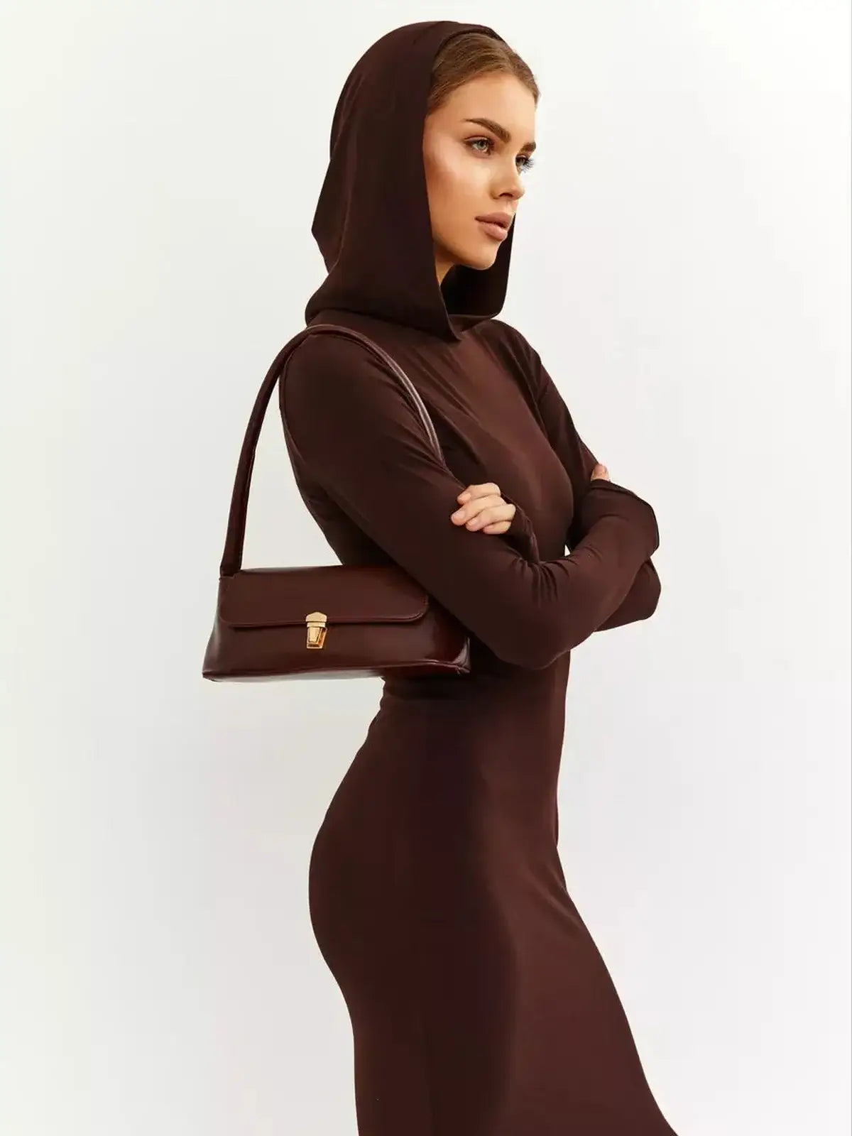 Model wearing a chocolate brown Sculpt Maxi Dress with a hood, showcasing elegant style and a sleek silhouette.