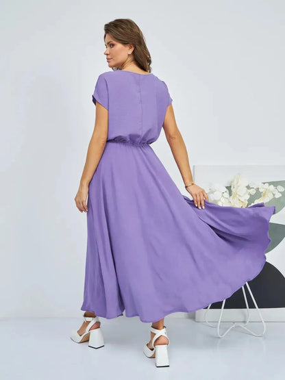 Model wearing a lavender maxi dress with lightweight fabric, showing elegant flow and gathered waist, ideal for summer occasions.