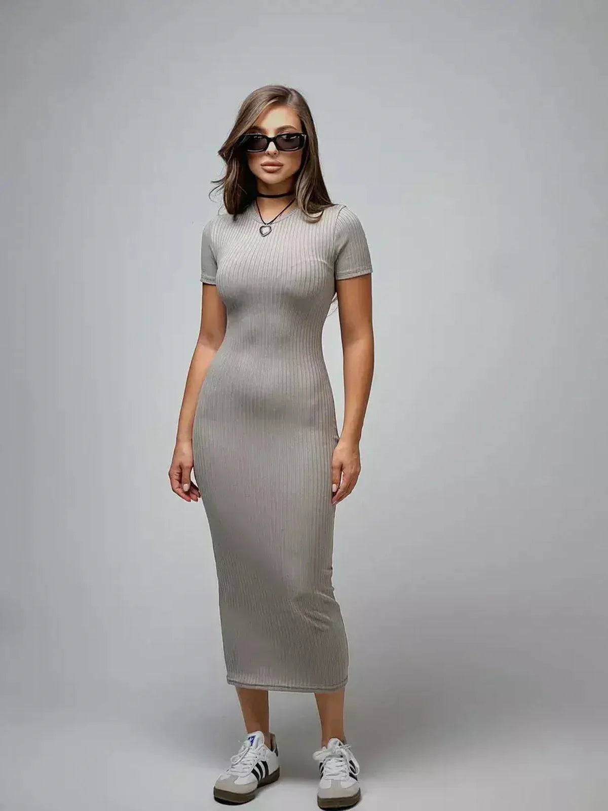 Model wearing a Sculpted Grace Maxi Dress in soft ribbed knit, showcasing a sleek silhouette and modern style.