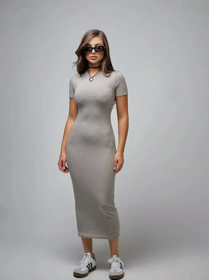 Model wearing a Sculpted Grace Maxi Dress in soft ribbed knit, showcasing a sleek silhouette and modern style.