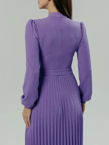 Back view of the violet Serena Midi Dress showcasing its elegant pleats and sculpted silhouette.