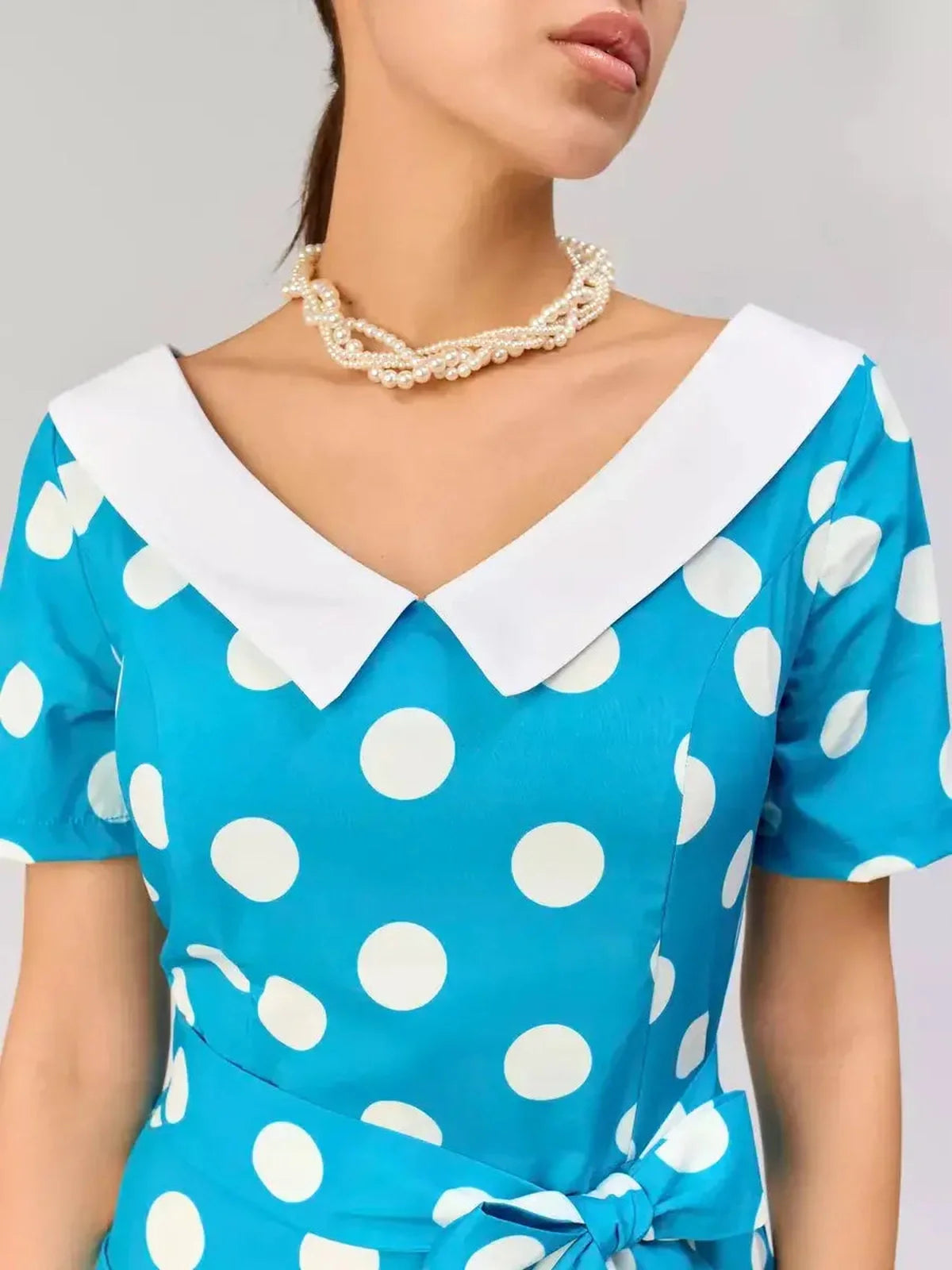 Retro Charm Midi Dress in blue with white polka dots and a contrast collar, perfect for summer and formal occasions.