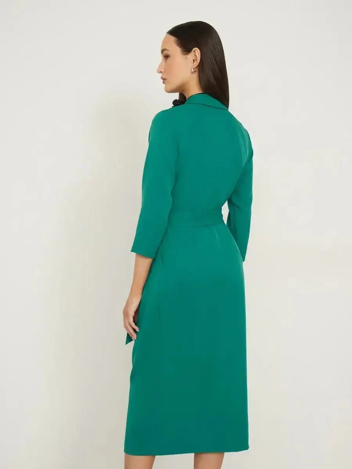 Back view of the Sculpted Grace Midi Dress in emerald green, featuring a belted waist and tailored elegance.