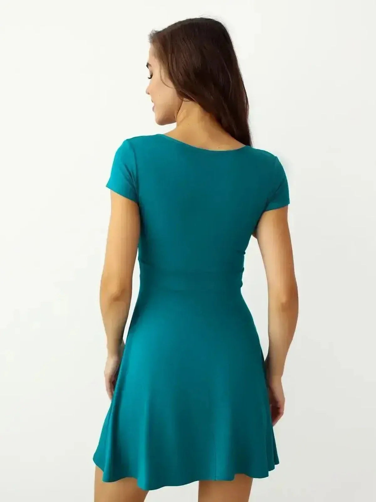 Back view of the Ocean Wrap mini dress in teal, showcasing its elegant short sleeves and flared silhouette.