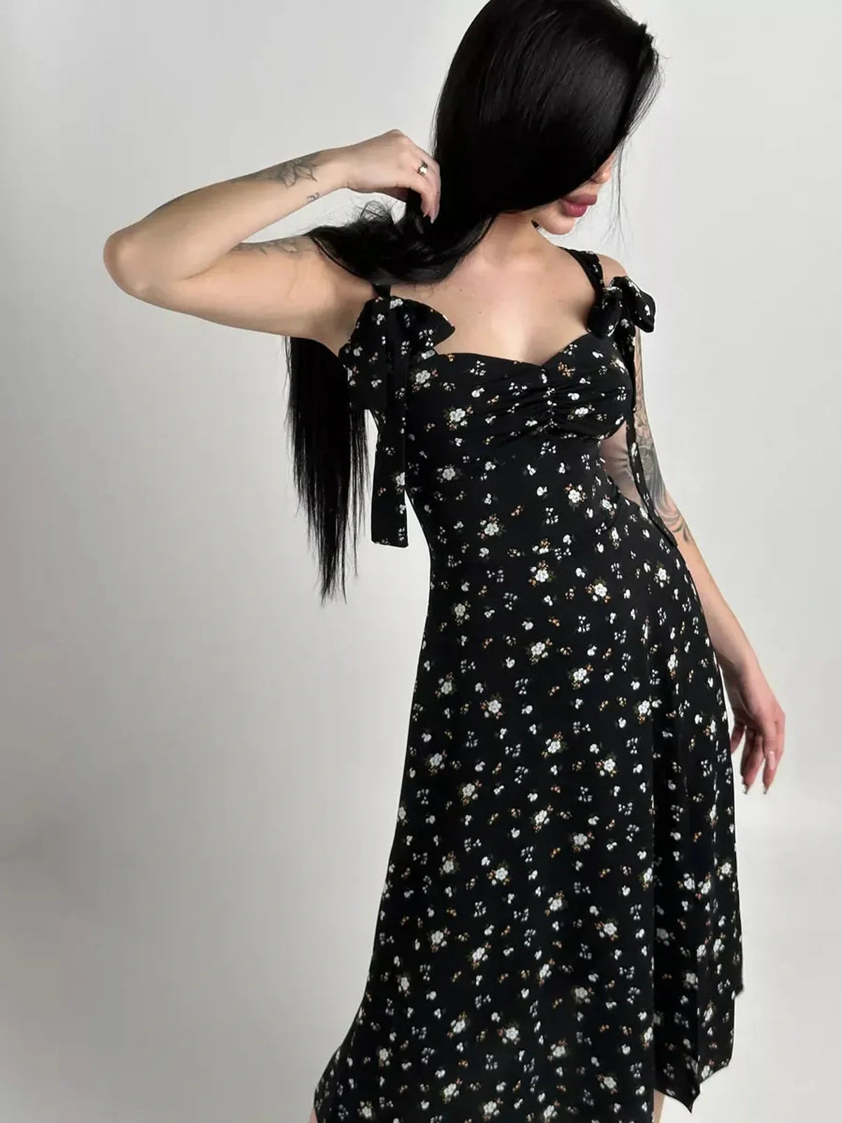 Elysian Midi Dress in black floral design with romantic bows, perfect for summer weddings and special occasions.