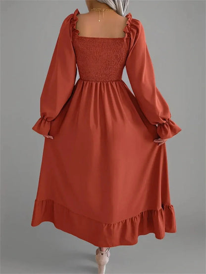 Rust Charm Midi Dress featuring a smocked bodice, flowy skirt, and romantic ruffled sleeves, perfect for summer and weddings.