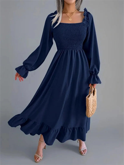Navy blue midi dress with smocked bodice and flounce hem, perfect for wedding guest and summer occasions.