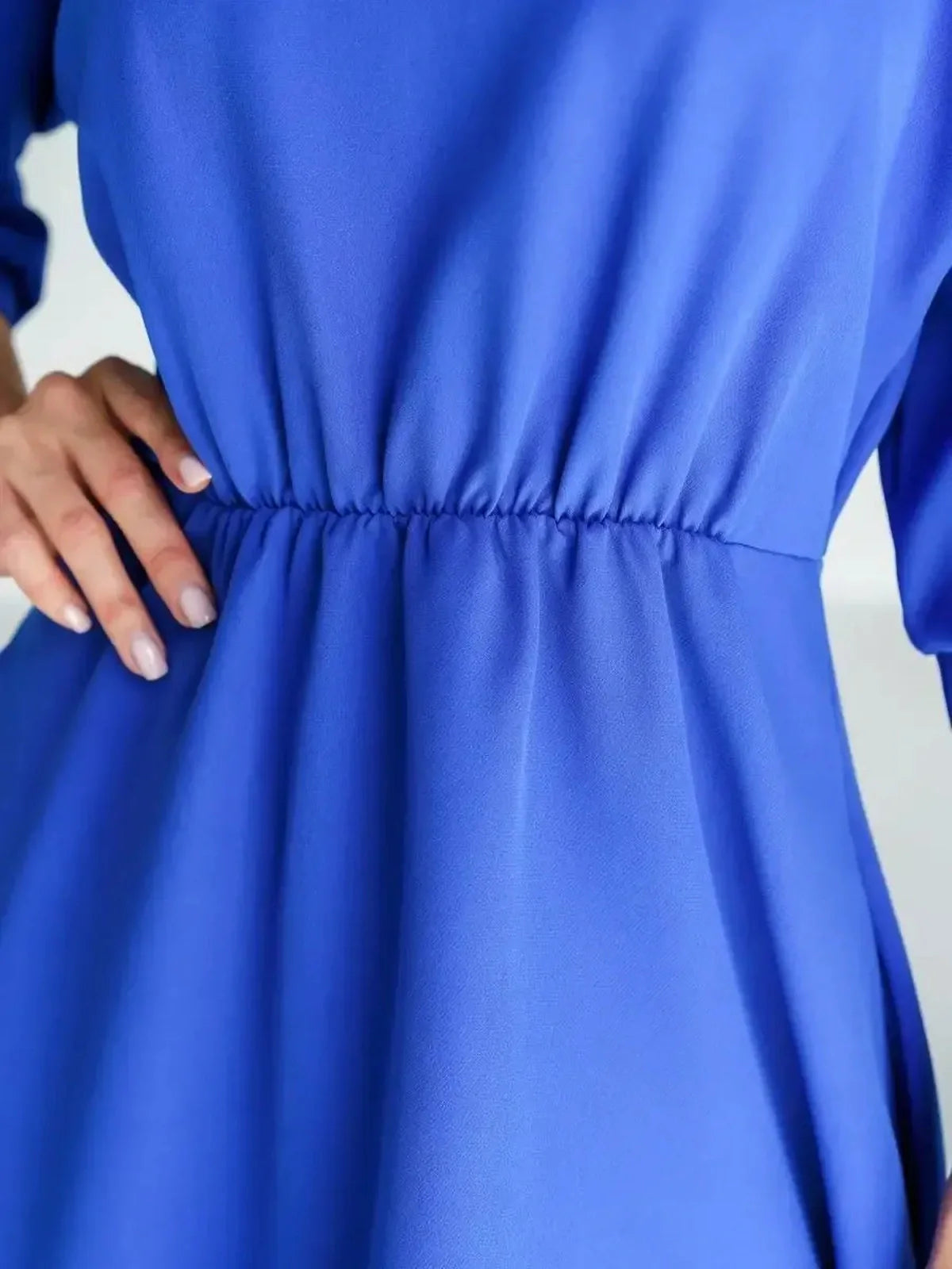 Close-up of the sleek waist detailing on the Sapphire Belted Midi Dress in vibrant electric blue.