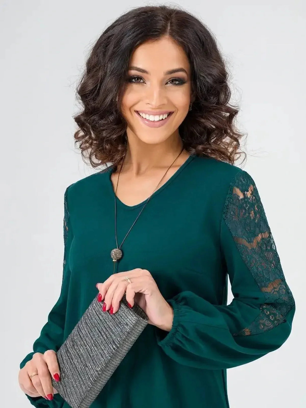 Elegant woman in a green Lace Charm mini dress with lace sleeves, showcasing a chic and sophisticated look for various occasions.