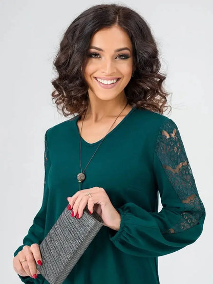 Elegant woman in a green Lace Charm mini dress with lace sleeves, showcasing a chic and sophisticated look for various occasions.
