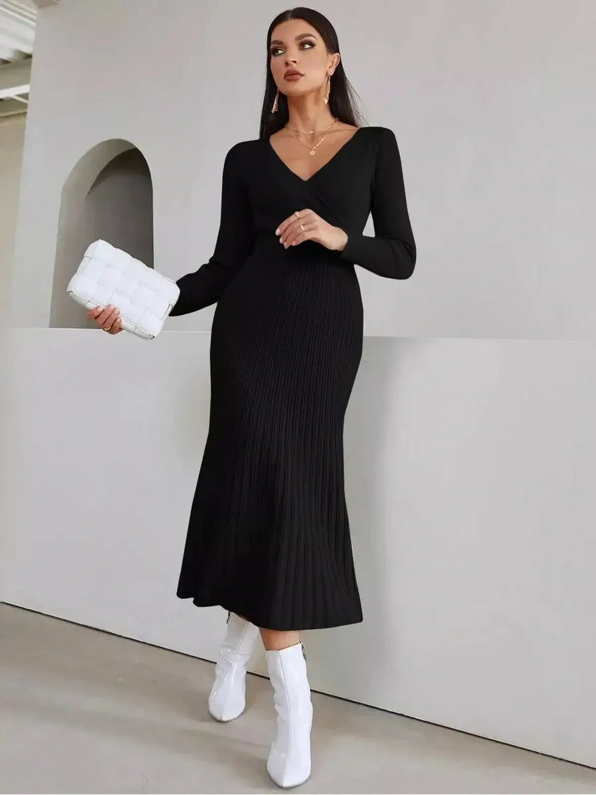Elegant black midi dress with ribbed texture and long sleeves, ideal for weddings and formal occasions.