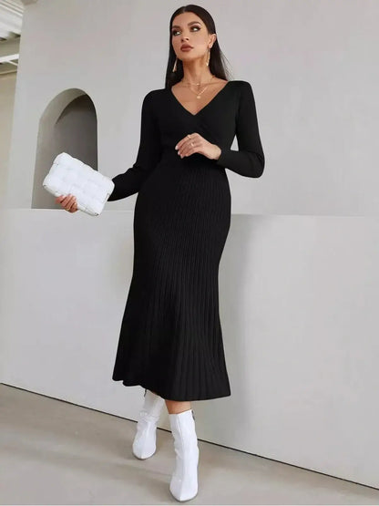 Elegant black midi dress with ribbed texture and long sleeves, ideal for weddings and formal occasions.