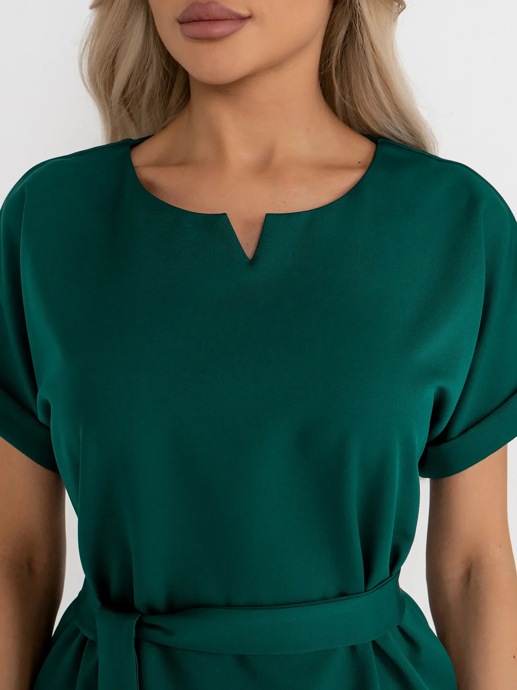 Emerald Mode green mini dress featuring a notched neckline and cuffed sleeves, perfect for weddings and formal events.
