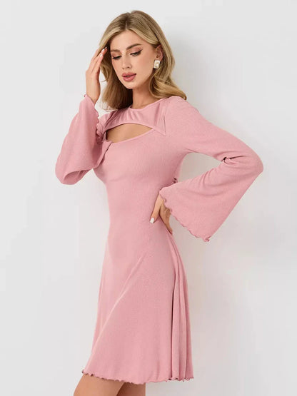 Model wearing a pink Blush Whisper dress featuring a U-neckline and flared sleeves, perfect for summer events.