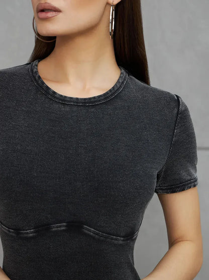 Close-up of a woman wearing a graphite form maxi dress with ribbed texture and minimalist design.