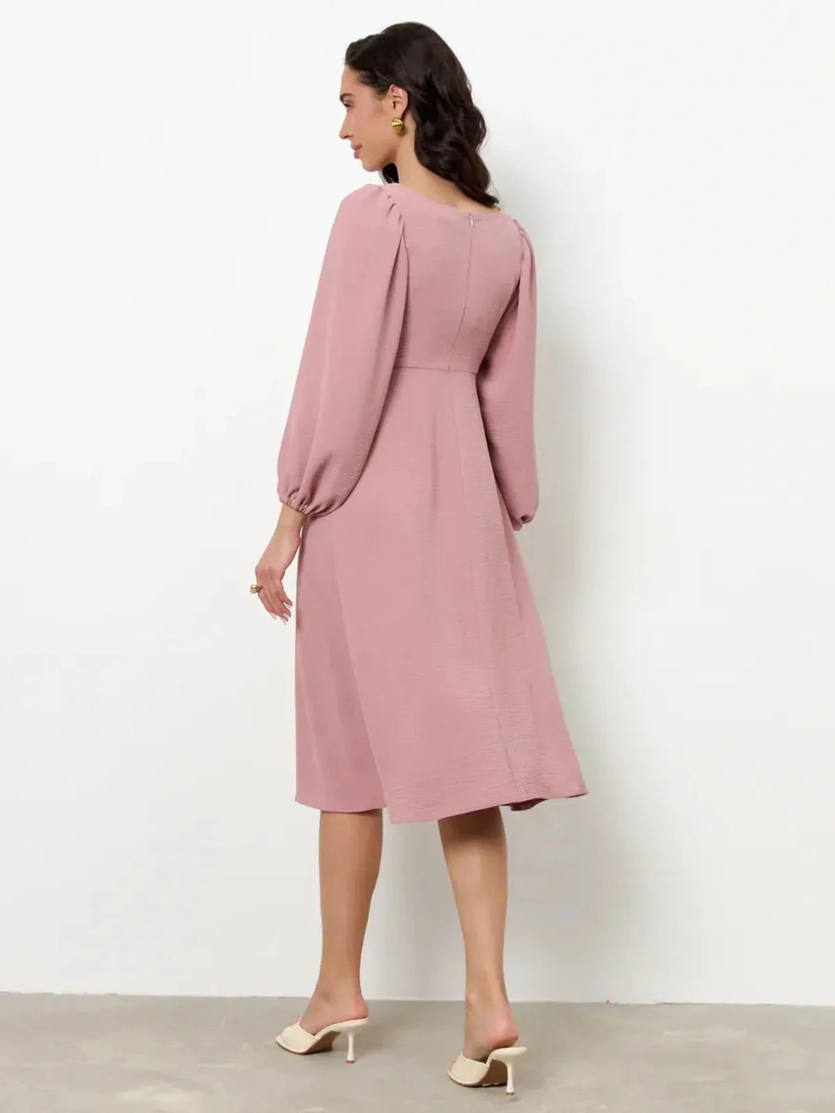 Back view of Blush Charm Midi Dress featuring romantic puff sleeves and a flowing skirt, perfect for formal events.