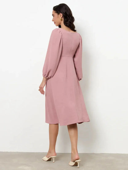 Back view of Blush Charm Midi Dress featuring romantic puff sleeves and a flowing skirt, perfect for formal events.
