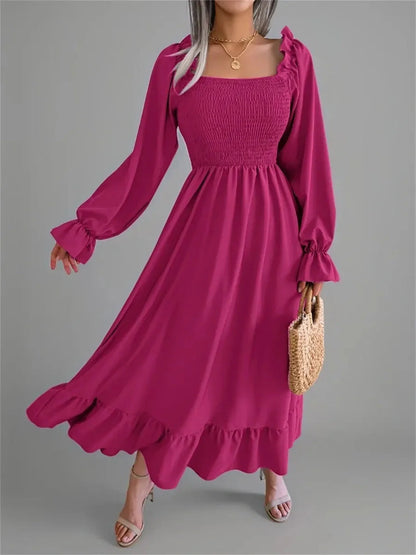 Stylish Roselle Midi Dress in bold magenta with smocked bodice and ruffled hem, perfect for weddings and casual outings.