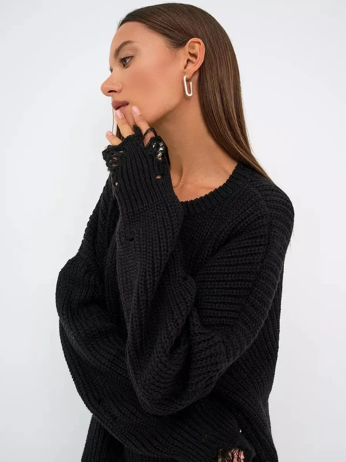 Model showcasing the Shadow Knit Mini dress in black with distressed texture and oversized fit.