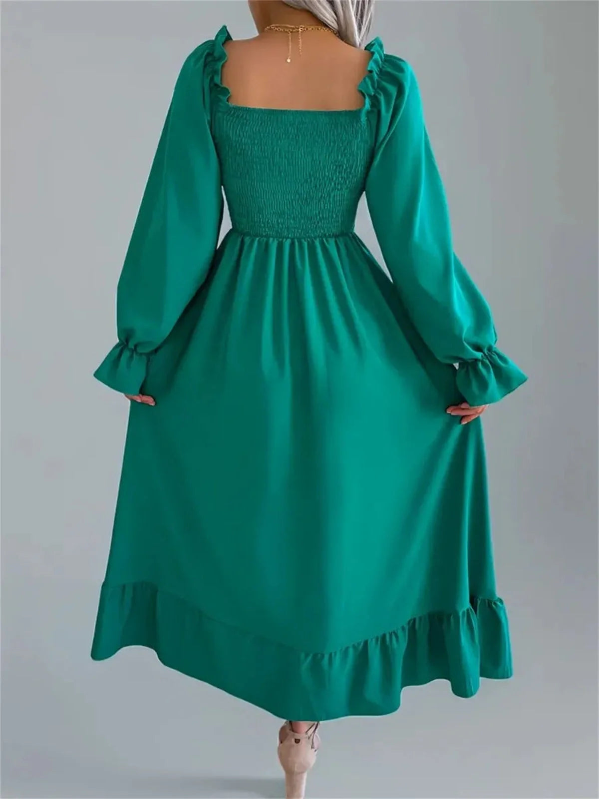 Meadow Ruffle Midi Dress in rich green, featuring a smocked bodice, long sleeves, and flowing skirt, perfect for weddings and formal occasions.