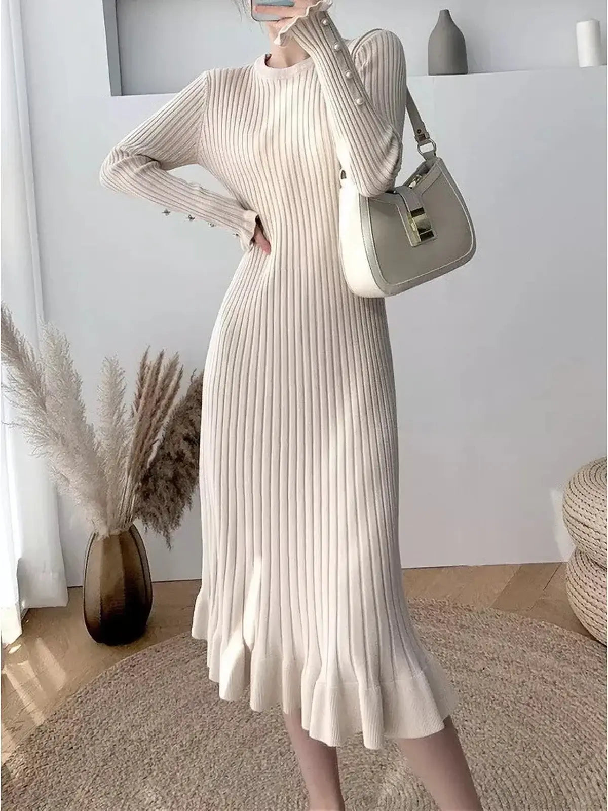 Elegant pearl flare midi dress in ribbed knit, featuring statement sleeves and decorative buttons, perfect for weddings or special occasions.