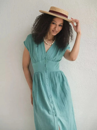 Model showcasing a sea-green Veranda Midi Dress with a corset waist, perfect for summer outings and wedding guest events.