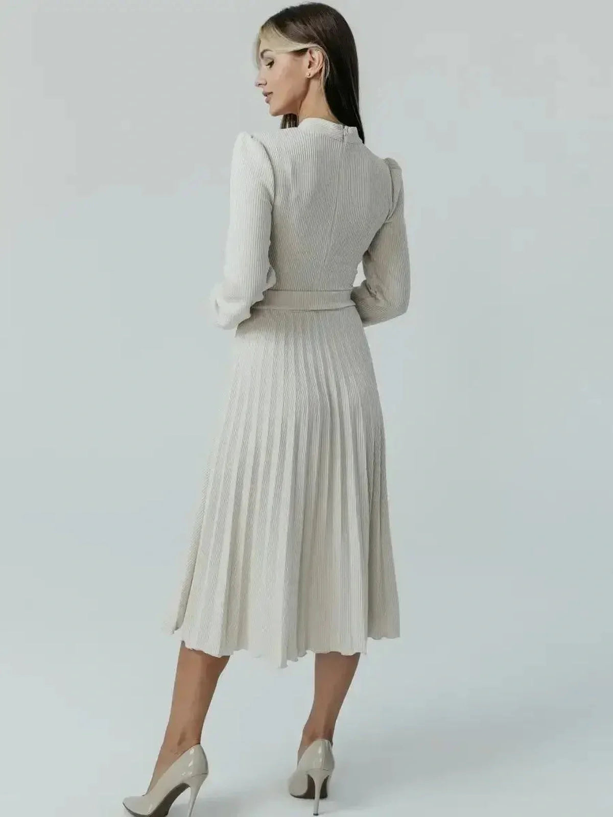 Back view of the Grace Pleat Midi Dress showcasing its elegant pleated skirt and fitted bodice in a soft ribbed knit.