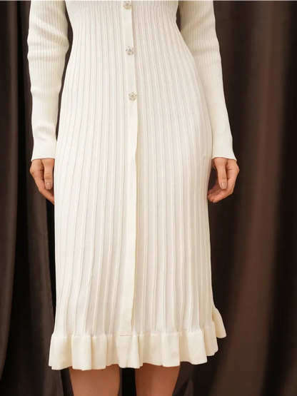 Front view of the Pearl Knit Midi Dress featuring ribbed texture, crystal buttons, and a ruffled hem, perfect for elegant occasions.