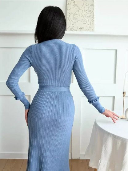 Back view of Serene Lines Midi Dress in blue, featuring ribbed knit texture and pearl-embellished cuffs, ideal for elegant occasions.