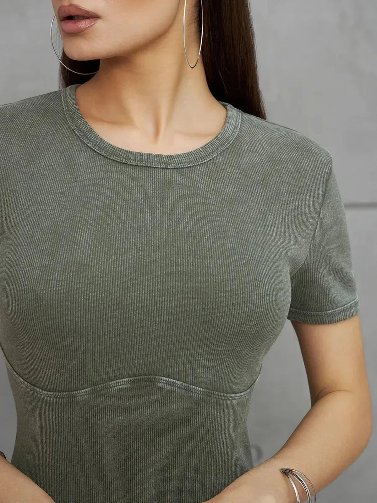 Close-up of the Olive Line Maxi Dress in khaki green ribbed cotton, showcasing its sculpted fit and minimalistic style.